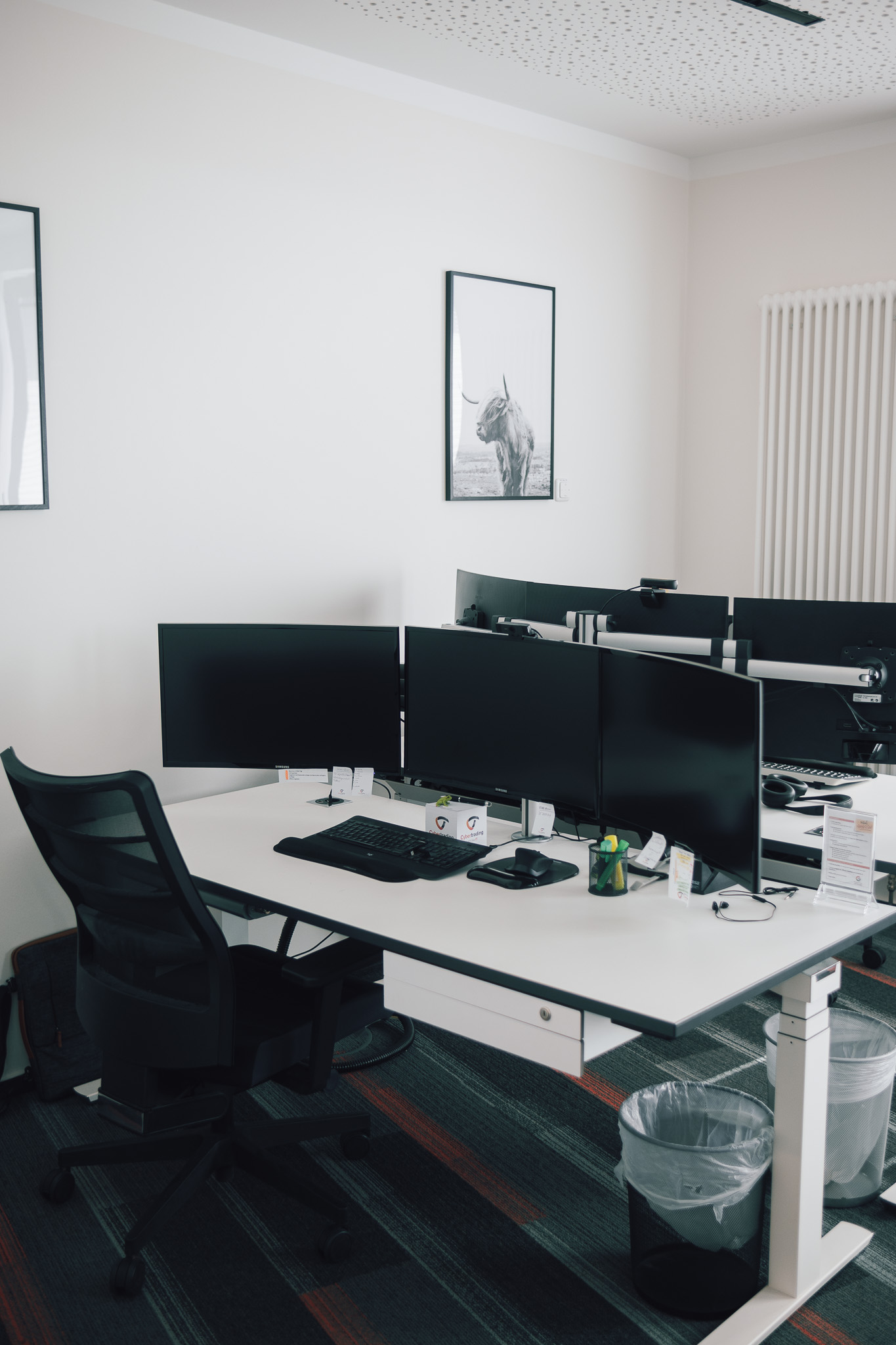 modern office room with multiple desktops and equipment