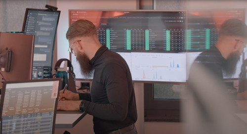 Man in front of computer screens