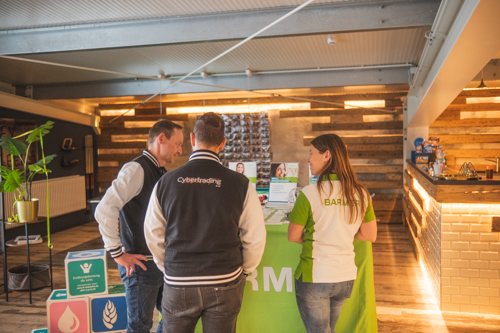 Three people in front of a booth about healthy food