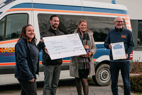 Managing Director, Head of Marketing hand over donation check to volunteers and Chairman of the Board of ASB Magdeburg