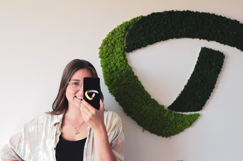 woman holds a mobile phone in front of her face